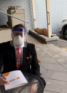 Adj Prof Brett Davies signing client's Will in Law Firm's carpark due to Australian COVID restriction